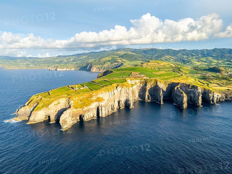 Cape Cintrao, Cliffs, Green Lush Hills, Fields, Pasturelands and Atlantic Ocean on Sunny Evening. Azores, Sao Miguel Island. Portugal. Aerial View