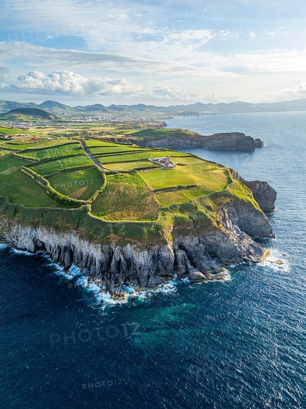 Cape Cintrao, Cliffs, Green Hills, Fields with Pasturelands and Atlantic Ocean. Azores, Sao Miguel Island. Portugal. Aerial View