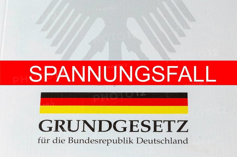 Tension case Symbolic image: SPANNUNGSFALL lettering, with the German Basic Law behind it