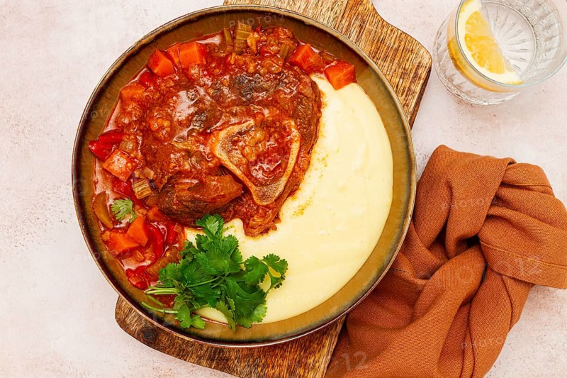 Ossobuco, stewed meat knuckle on the bone, with mashed potatoes, and oats and spices, homemade, no people
