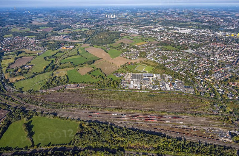 Aerial view, marshalling yard Hamm, industrial area Schieferstraße and slag heap Kissinger Höhe and slag heap Humbert, CreativRevier Hamm, former mine Ost Heinrich Robert, view to RWE Generation SE power plant Gersteinwerk with chimney and cooling towers, district Pelkum, Hamm, Ruhr area, North Rhine-Westphalia, Germany, railway area, slag heap, CreativRevier Heinrich Robert, DE, Deutsche Bahn AG, Europe, commercial enterprise, commercial area, commercial area, commercial property, commercial location, commercial use, railway tracks, tracks, property tax, goods trains, real estate, industrial area, industrial location, aerial view, aerial photography, aerial photography, overview, bird's-eye view, residential area, residential area, residential quality, residential neighbourhood, residential estate, residential district, birds-eyes view, overview