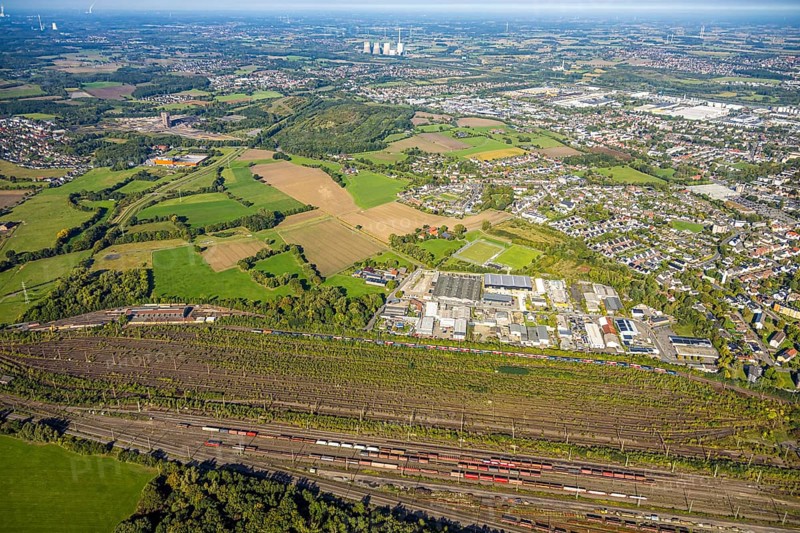 Aerial view, marshalling yard Hamm, industrial area Schieferstraße and slag heap Kissinger Höhe and slag heap Humbert, CreativRevier Hamm, former mine Ost Heinrich Robert, view to RWE Generation SE power plant Gersteinwerk with chimney and cooling towers, district Pelkum, Hamm, Ruhr area, North Rhine-Westphalia, Germany, railway area, slag heap, CreativRevier Heinrich Robert, DE, Deutsche Bahn AG, Europe, commercial enterprise, commercial area, commercial area, commercial property, commercial location, commercial use, railway tracks, tracks, property tax, goods trains, real estate, industrial area, industrial location, aerial view, aerial photography, aerial photography, overview, bird's-eye view, residential area, residential area, residential quality, residential neighbourhood, residential estate, residential district, birds-eyes view, overview