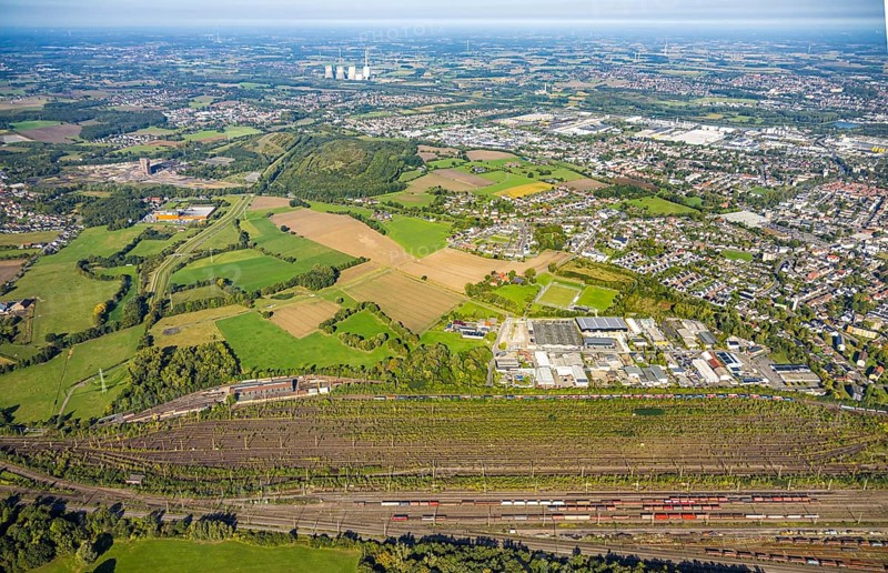 Aerial view, marshalling yard Hamm, industrial area Schieferstraße and slag heap Kissinger Höhe and slag heap Humbert, CreativRevier Hamm, former mine Ost Heinrich Robert, view to RWE Generation SE power plant Gersteinwerk with chimney and cooling towers, district Pelkum, Hamm, Ruhr area, North Rhine-Westphalia, Germany, railway area, slag heap, CreativRevier Heinrich Robert, DE, Deutsche Bahn AG, Europe, commercial enterprise, commercial area, commercial area, commercial property, commercial location, commercial use, railway tracks, tracks, property tax, goods trains, real estate, industrial area, industrial location, aerial view, aerial photography, aerial photography, overview, bird's-eye view, residential area, residential area, residential quality, residential neighbourhood, residential estate, residential district, birds-eyes view, overview