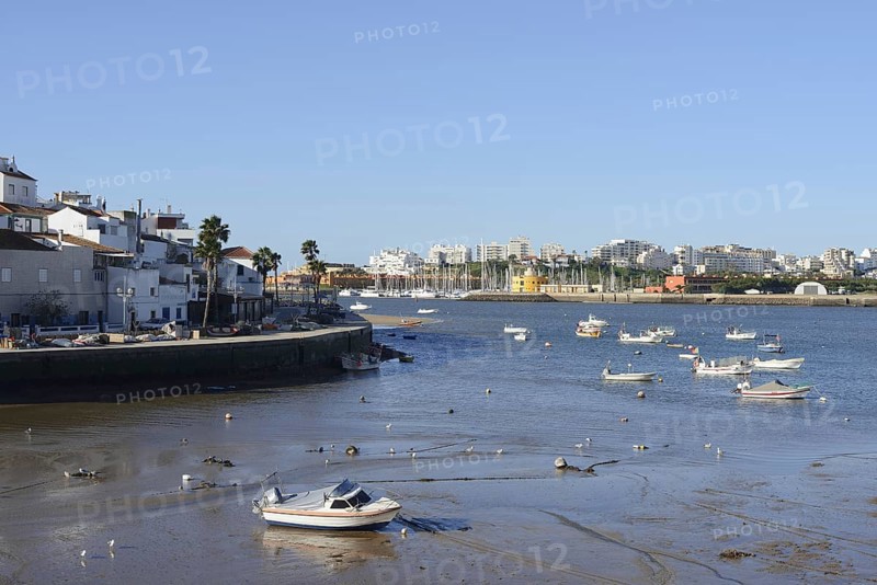 View over the mouth of the river Arade with fishing boats to Portimao, Ferragudo, Algarve, Portugal