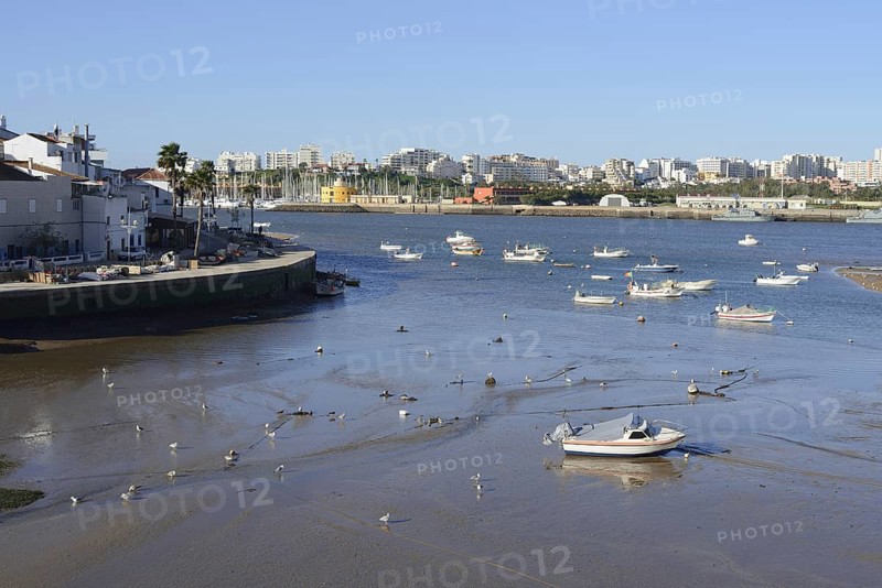 View over the mouth of the river Arade with fishing boats to Portimao, Ferragudo, Algarve, Portugal