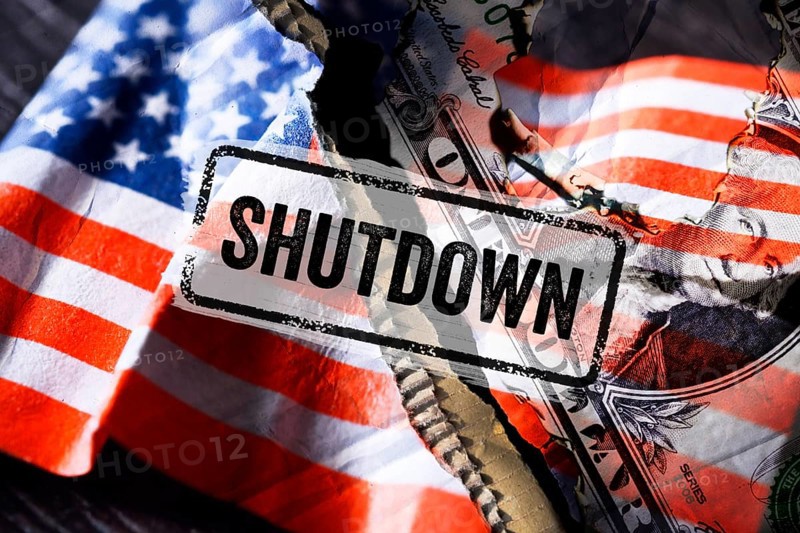 Torn US flag with dollar bill and Shutdown lettering, photomontage