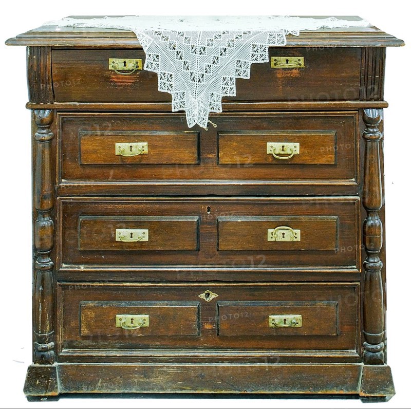 A vintage chest of drawers covered with an openwork crocheted doily