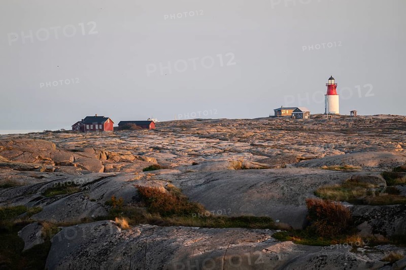 Lighthouse and houses in stony landscape at sunset, archipelago, Smögen, Smögenbryggan, Västra Götalands Län, Bohuslän, Sweden