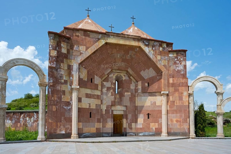 Front view of a stone church with striking arches and three crosses on the roof, Saint Trinity Altar of Hope, Aparan, Aragazotn Province, Armenia