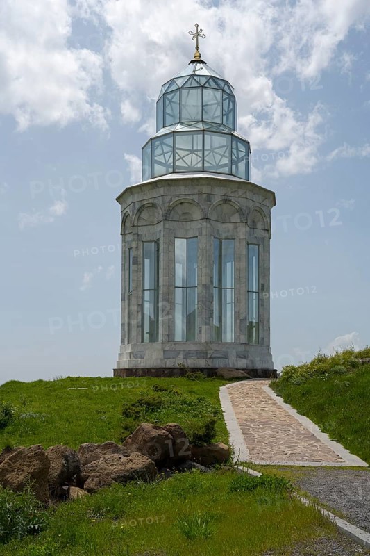 Glass church with decorative cross in a meadow under a blue sky, Garden of Eternity, Aparan, Aragazotn Province, Armenia