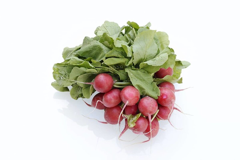 Radish (Raphanus sativus var. sativus) with leaves against a white background