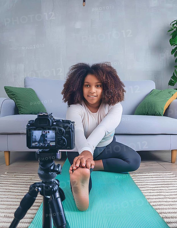 A young woman is doing a yoga pose in front of a camera. The camera is on a tripod and is recording her pose, AI generated