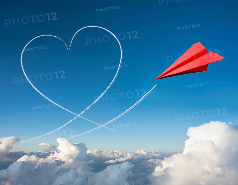 A red paper airplane depicted in flight with an artistic heart-shaped trail. The blue sky background provides a striking contrast, emphasizing creativity and imagination, AI generated