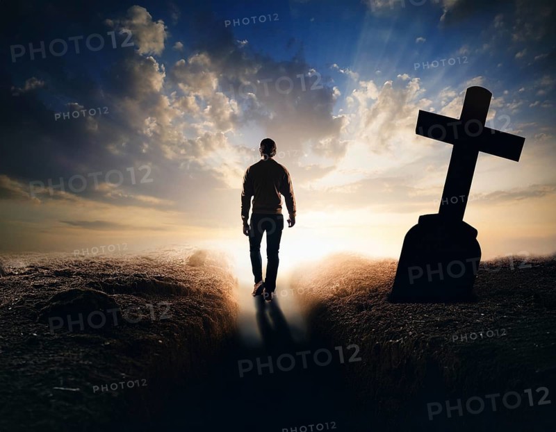 A silhouette of a lone figure walking off a gravestone, The scene evokes Resurrection thoughts emotional depth, AI generated