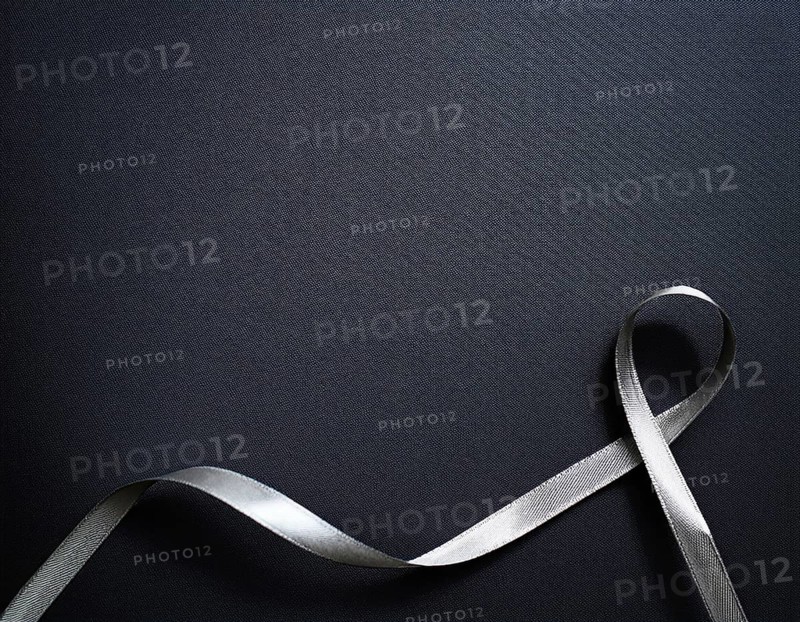 A beautifully wrapped gift box adorned with colorful satin ribbons forming a bow, contrasting against a linear textured surface, evoking feelings of celebration and elegance, AI generated