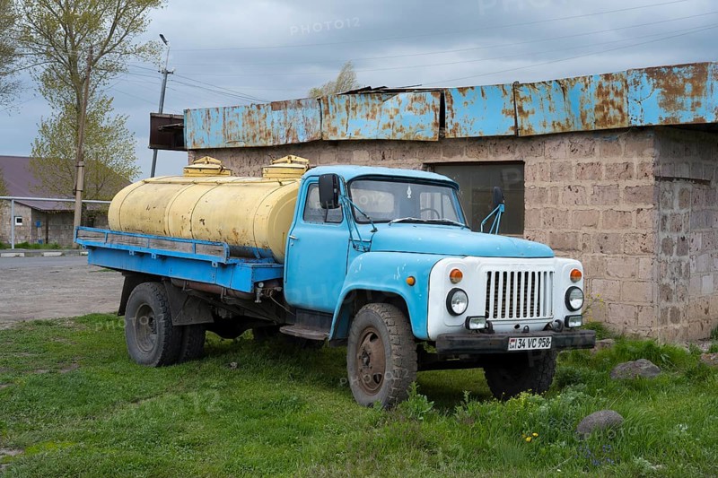 An old blue lorry with yellow tanks stands abandoned in a rural setting, GAZ-53 lorry, tanker, Armenia