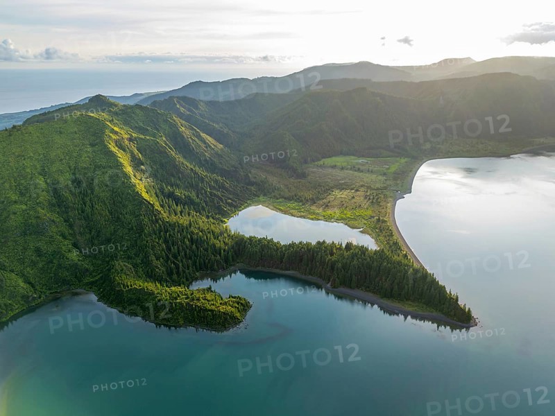 Lagoa do Fogo Lake on Sunny Morning. Green Lush Hills with Forest and Mountains. Azores, Sao Miguel Island. Portugal. Aerial Drone Shot