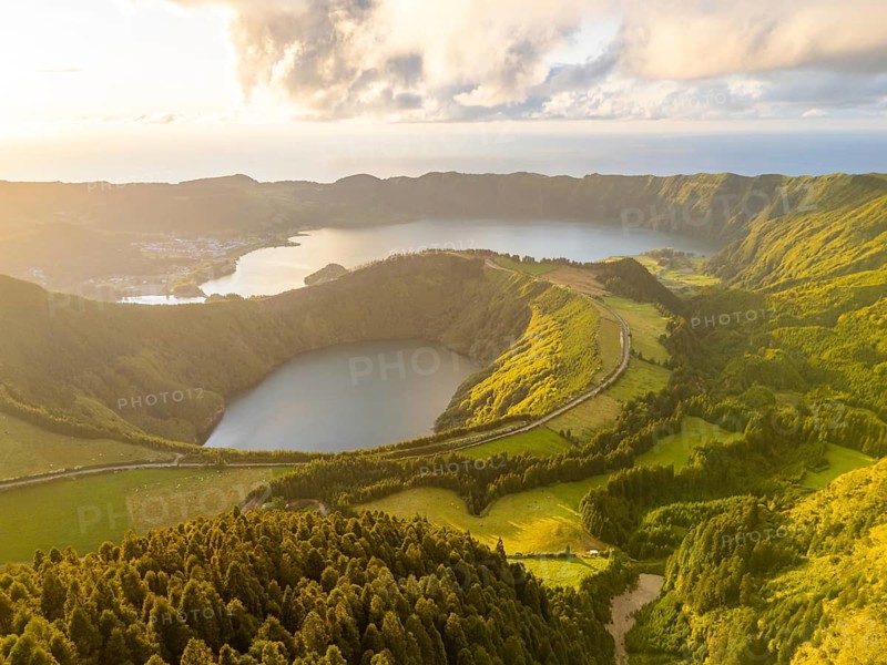 Sete Cidades Caldera on Sunny Evening. Blue Lake and Santiago Lake. Forest and Hills with Pasturelands. Azores, Sao Miguel Island. Portugal. Aerial View
