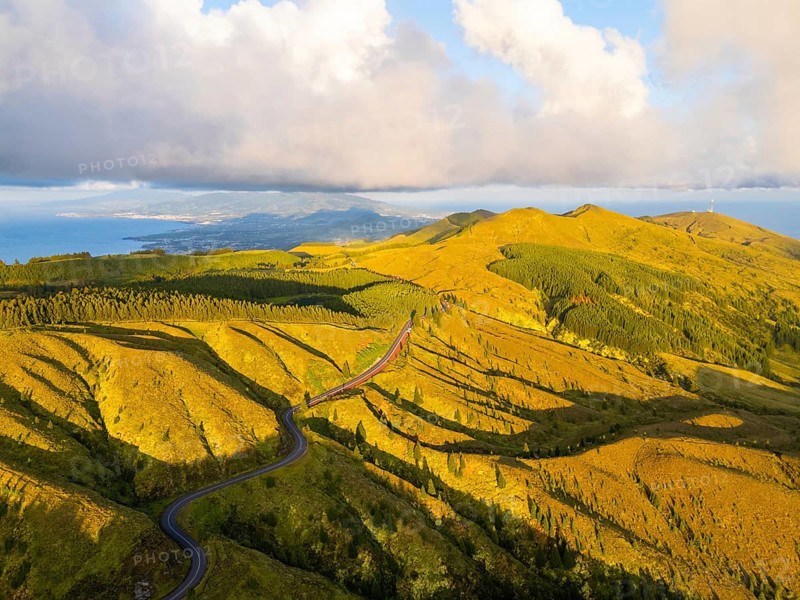 Green Forest Hills at Sunset with Pastureland. Atlantic Ocean. Azores, Sao Miguel Island, Portugal. Aerial View. Golden Hour