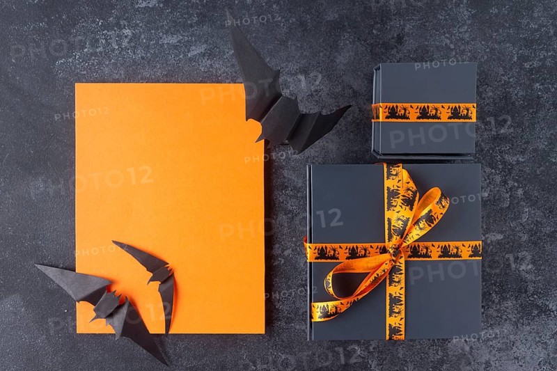 Gifts for the celebration of Halloween, orange place for text, on a black background
