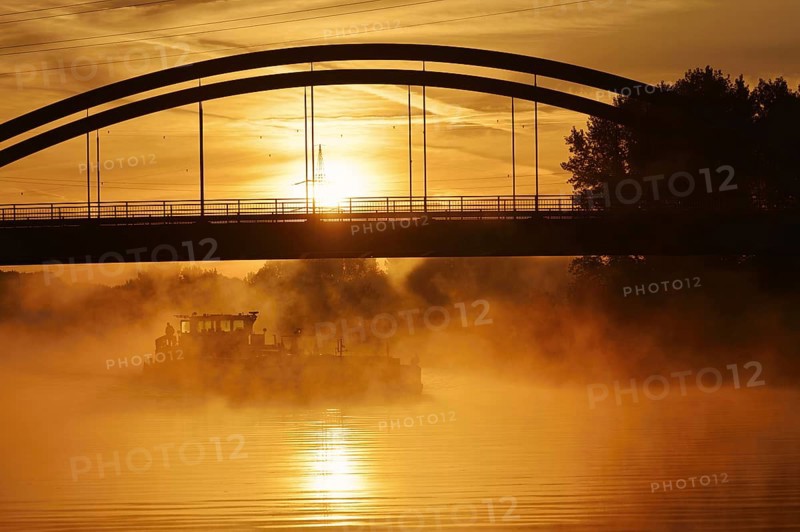Ship on the Datteln-Hamm Canal in the morning fog at sunrise, Bergkamen, North Rhine-Westphalia, Germany