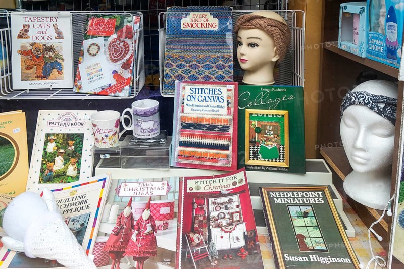 Shop window display books materials for stitching and smocking, Make Do And Mend shop, The Brittox, Devizes, Wiltshire, England, UK