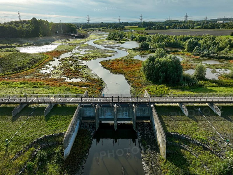 Dortmund, Castrop-Rauxel, North Rhine-Westphalia, Germany - River renaturalisation, renaturation of the Emscher, flood retention basin HRB Mengede. A new floodplain landscape is being created at the Emscher-Auen farm, expanding the area for flood protection during heavy rainfall and for biodiversity. The previously straightened Emscher is being given curves again and can meander through its new floodplain. Following the construction of a parallel sewer, the Emscher has been completely free of sewage since 2022. The river was previously an open, above-ground combined sewer with rainwater and wastewater