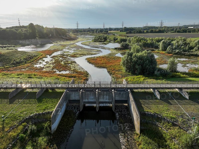 Dortmund, Castrop-Rauxel, North Rhine-Westphalia, Germany - River renaturalisation, renaturation of the Emscher, flood retention basin HRB Mengede. A new floodplain landscape is being created at the Emscher-Auen farm, expanding the area for flood protection during heavy rainfall and for biodiversity. The previously straightened Emscher is being given curves again and can meander through its new floodplain. Following the construction of a parallel sewer, the Emscher has been completely free of sewage since 2022. The river was previously an open, above-ground combined sewer with rainwater and wastewater
