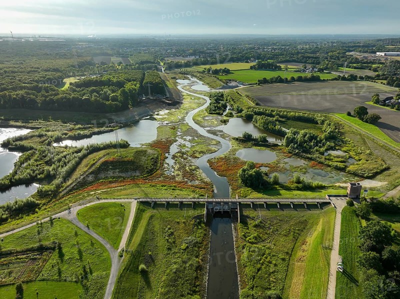 Dortmund, Castrop-Rauxel, North Rhine-Westphalia, Germany - River renaturalisation, renaturation of the Emscher, flood retention basin HRB Mengede. A new floodplain landscape is being created at the Emscher-Auen farm, expanding the area for flood protection during heavy rainfall and for biodiversity. The previously straightened Emscher is being given curves again and can meander through its new floodplain. Following the construction of a parallel sewer, the Emscher has been completely free of sewage since 2022. The river was previously an open, above-ground combined sewer with rainwater and wastewater