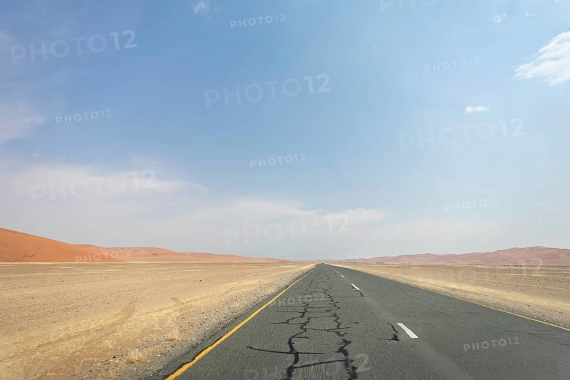 Inside Sossusvlei, gravel roads wind through red dunes to Deadvlei, Big Daddy, and Sesriem Canyon, offering scenic, dusty desert views, Namibia