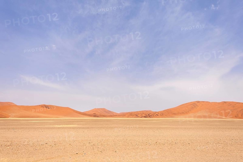 Sossusvlei in Namibia is a desert wonder, famous for its giant red dunes, glowing at sunrise and sunset, and its hauntingly beautiful dead tree valleys