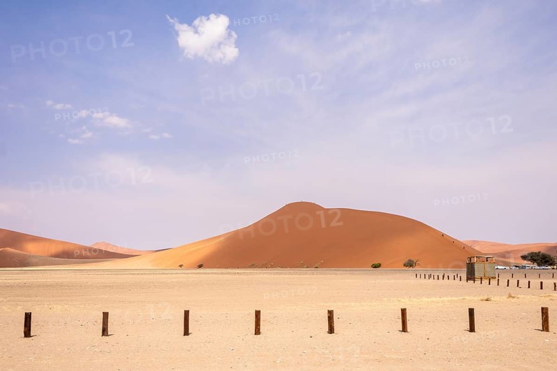 Sossusvlei in Namibia is a desert wonder, famous for its giant red dunes, glowing at sunrise and sunset, and its hauntingly beautiful dead tree valleys