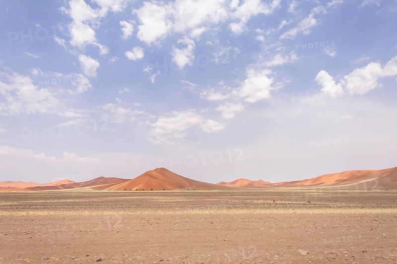 Sossusvlei in Namibia is a desert wonder, famous for its giant red dunes, glowing at sunrise and sunset, and its hauntingly beautiful dead tree valleys
