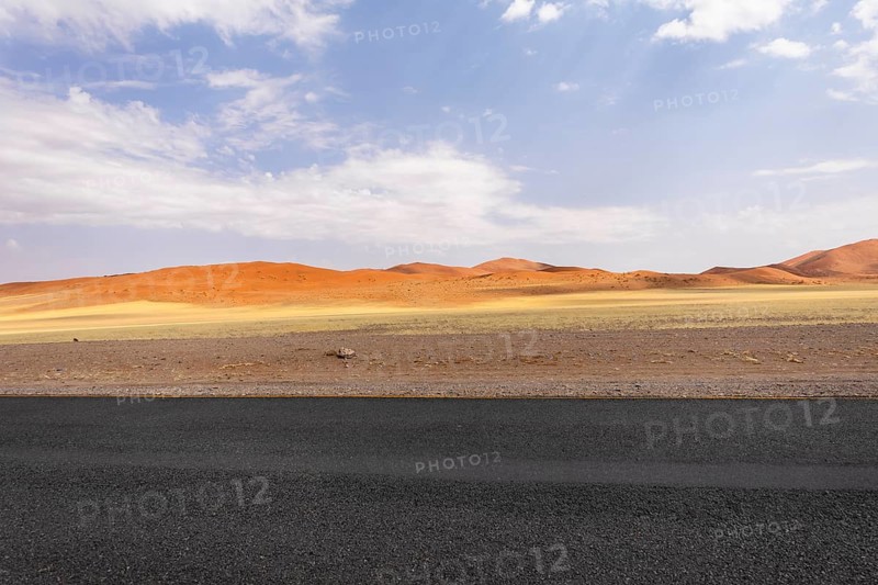 Sossusvlei in Namibia is a desert wonder, famous for its giant red dunes, glowing at sunrise and sunset, and its hauntingly beautiful dead tree valleys