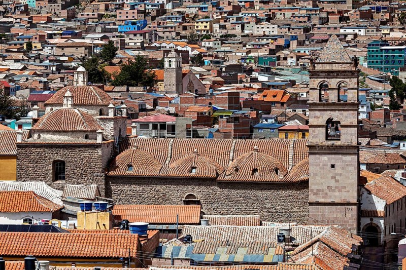 Densely built-up city scene with brick towers and colonial architecture in the foreground, The churches of the city of Potosi in Bolivia