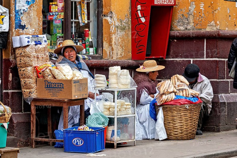Women selling traditional food at a street stall in Peru, Bolivian Indio woman selling goods in the streets of Potosi Bolivia