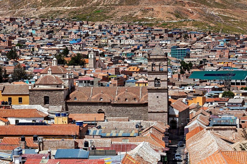 Aerial view of a densely built-up city with colonial towers and colourful roofs in a mountainous region, The churches of the city of Potosi in Bolivia