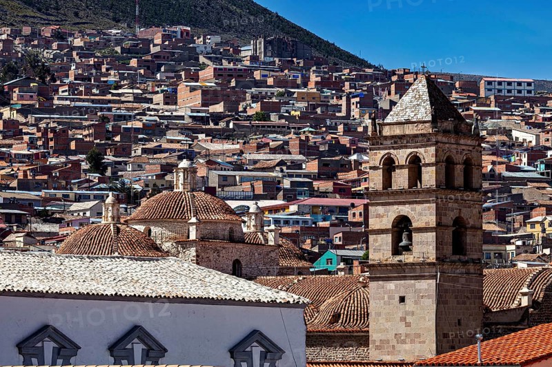 Historic cityscape with towers and densely built-up areas under a blue sky, view over the city of Potosi in Bolivia