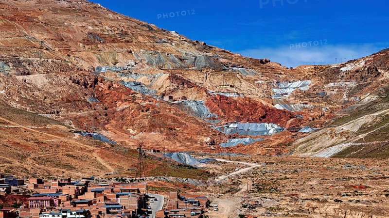 Reddish mountain landscape with visible mines under a clear sky, the Cerro Rico silver mountain in Potosi, Bolivia