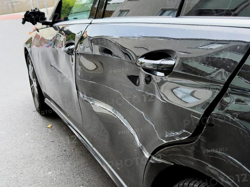 Dented car door after traffic accident, significant bodywork damage to a car in Wuppertal, Germany