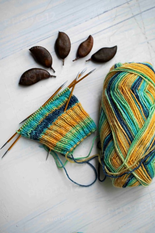 Coloured wool with started knitted sock