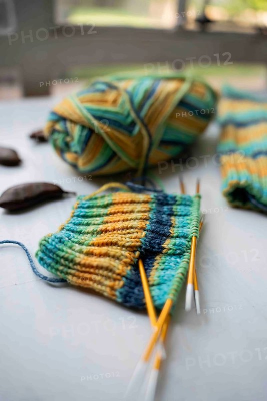Coloured wool with started knitted sock