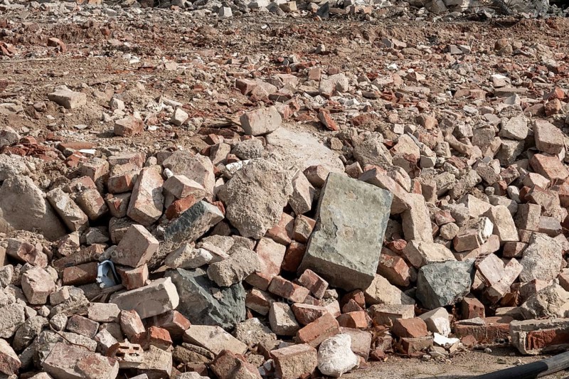 Accumulation of broken bricks and concrete from construction demolition site