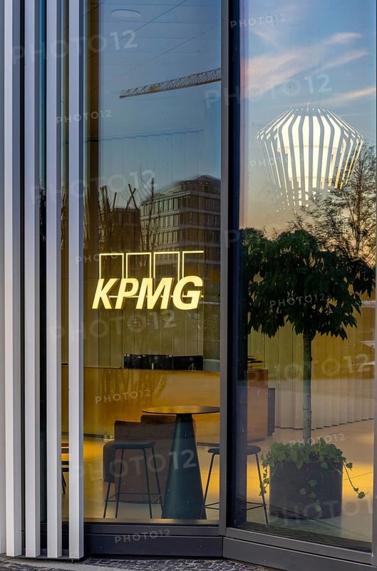 The picture shows the interior of a modern Berlin restaurant, taken in the evening, the scene is characterised by modern lighting fixtures reminiscent of large, glowing light bulbs, Berlin, Germany