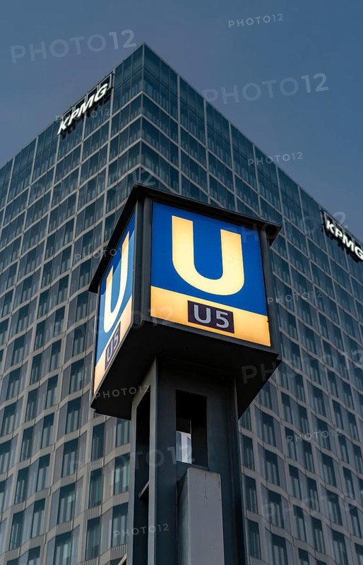 The picture shows a modern high-rise building in Berlin with the KPMG logo and a striking underground station sign for the U5 line, Berlin, Germany