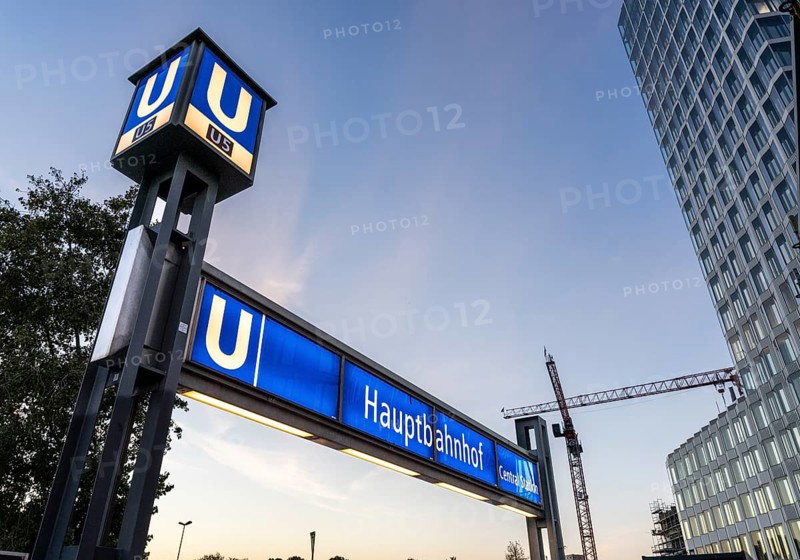 The picture shows a modern high-rise building in Berlin and a striking underground station sign from the main railway station and the U5 line, Berlin, Germany