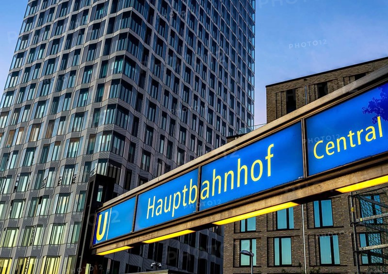 The picture shows a modern high-rise building in Berlin and a striking underground station sign from the main railway station and the U5 line, Berlin, Germany