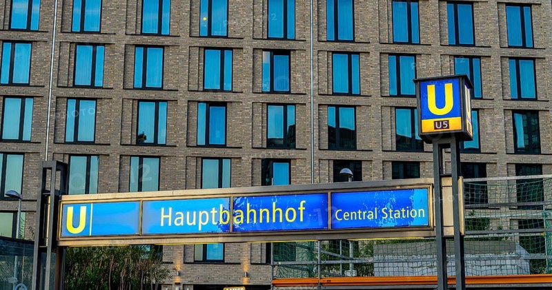 The picture shows a modern high-rise building in Berlin and a striking underground station sign from the main railway station and the U5 line, Berlin, Germany