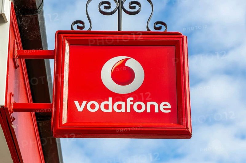 Vodafone sign with logo on shopfront of Vodafone phone shop, Marlborough, Wiltshire, England, UK