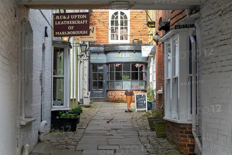 Specialist shops in historic alleyway of Old Hughenden Yard off the High Street in Marlborough, Wiltshire, England, UK